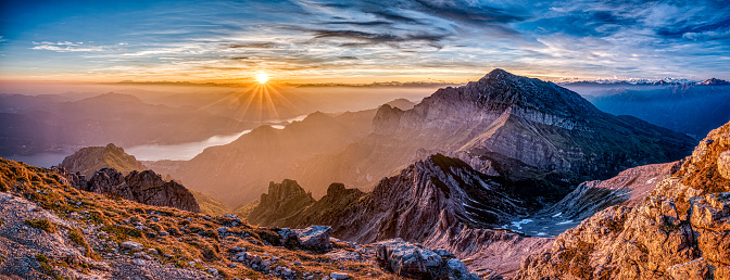 Aerial view of the sunrise at the Glatthorn (2133m) in Vorarlberg, the most western part of Austria. There are a few anonymous people in their sleeping bags at the top of the mountain.