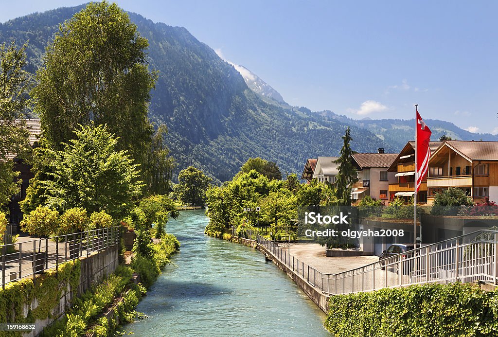 River between houses and trees in Interlaken, Switzerland Beautiful view of the river and the house to Interlaken, Switzerland Interlaken - Switzerland Stock Photo