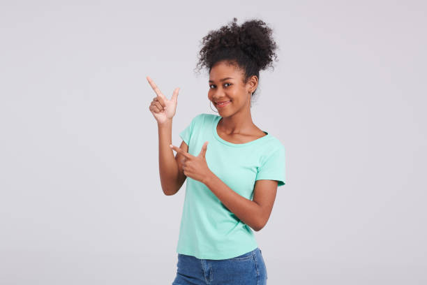 istock Fashion Still: Woman's Mint Shirt and Blue Jeans Studio Posture 1591698968