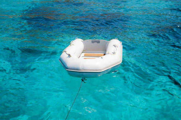 istock White inflatable boat floating in clear sea 1591703917