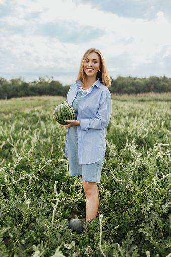 Full body portrait of the young casually dressed watermelon producer