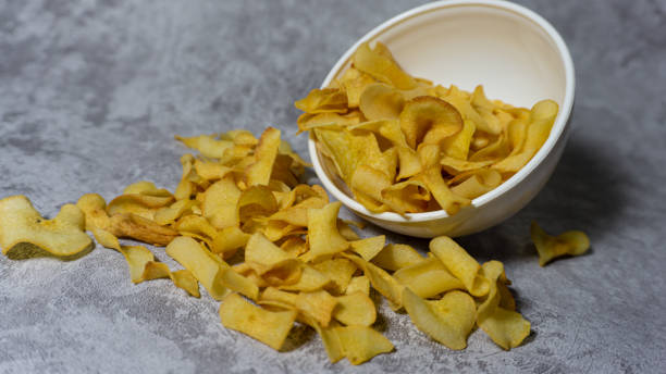 istock Cassava chips in white plastic bowl isolated on gray background 1591725606