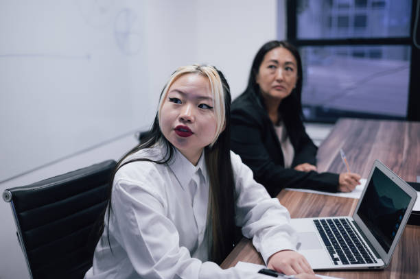istock Two Asian business colleagues at a conference table 1591744341