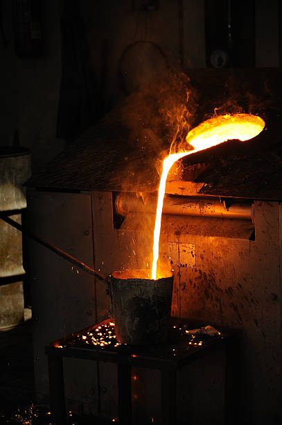 Foundry - Molten metal poured from lathe for casting stock photo