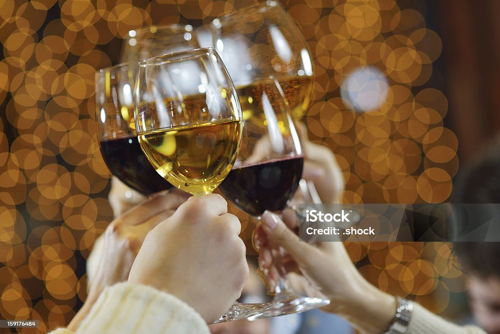Glasses of champagne and wine in a toast Celebration. Hands holding the glasses of champagne and wine making a toast. Adult Stock Photo