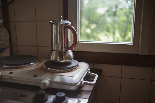 Liminal space with a single Italian coffee maker on the stove