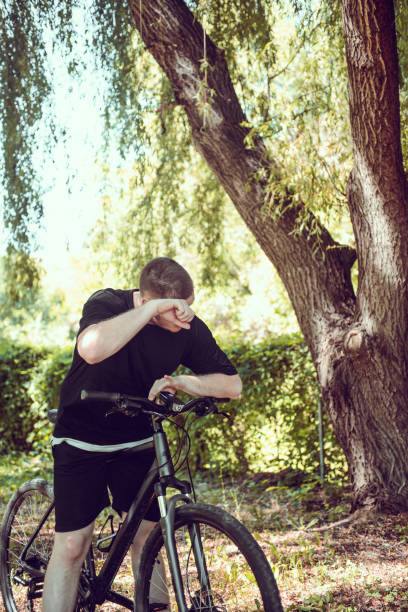 istock Male Wiping Sweat After Riding Bicycle Outside 1591773464