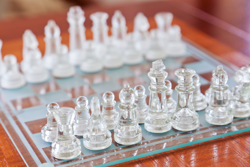 Chess board with glass chess, selective focus