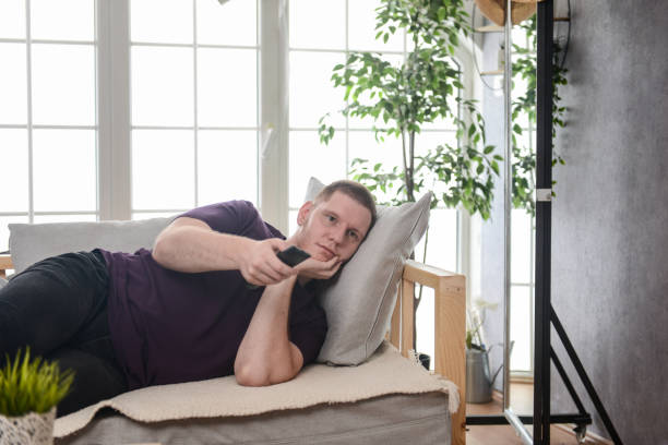 istock Male Relaxing At Home Watching TV 1591776130