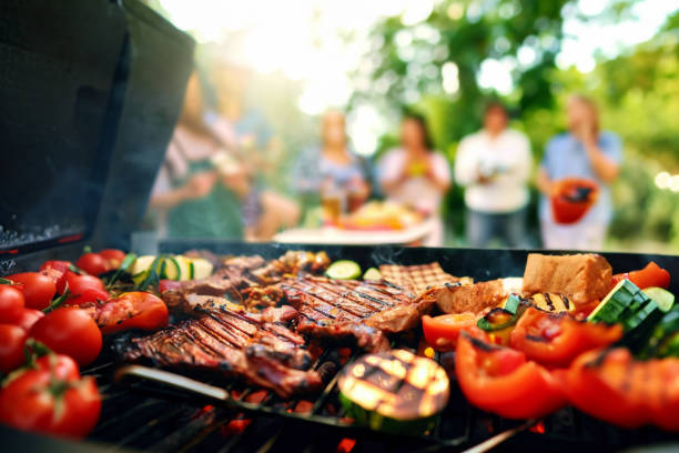 Grilling Extravaganza. Delicious Food and Joyful Celebrations in the Background Grilling Extravaganza. Delicious Food and Joyful Celebrations in the Background bbq stock pictures, royalty-free photos & images
