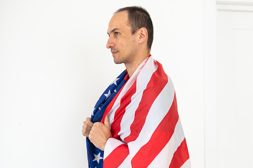 Man with USA flag on white background. Memorial Day celebration. High quality photo