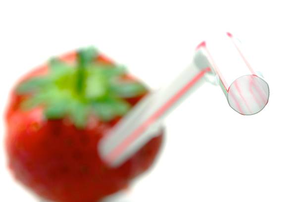 Strawberry with straw: Invitation to eat healthily stock photo