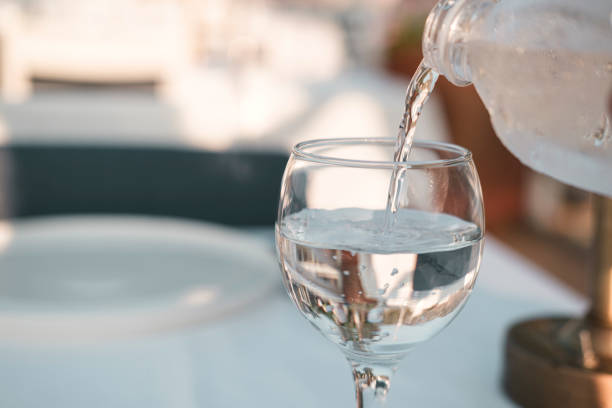 istock pouring water into glass, cool cold pure beverage 1591791153