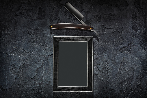 Barbers Concept Stright Razor And Vintage Frame With Blank Paper Sheet Mock Up On Stone Slate Background