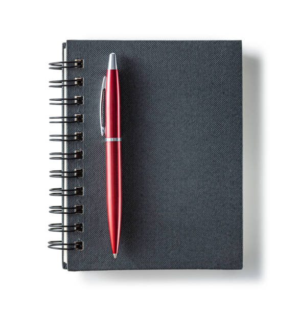 istock Black Notepad And Red Ballpoint Pen Isolated. 1591810841
