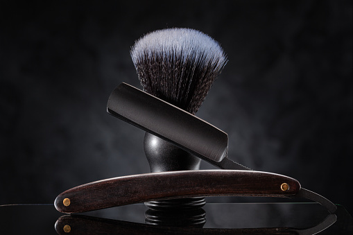 Black Barber Tools. Stright Razor And Classic Shaving Brush On Abstract Background.
