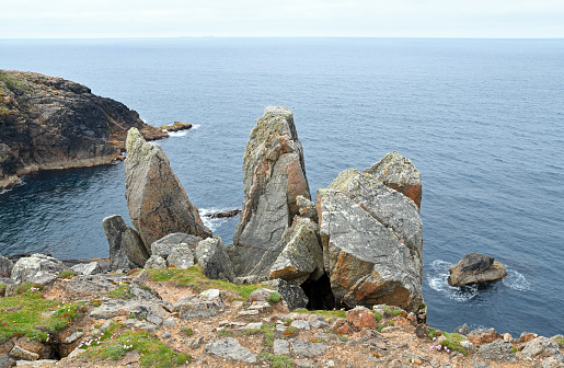 Lewisian gneiss cliffs and rock stacks at Mangersta. This type of rock is the oldest in Britain and dates back to c.3000 million years ago. These rocks, which were mostly granite-like in origin, have experienced numerous upheavals.