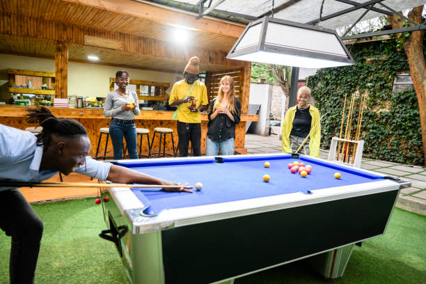 istock Friends playing pool at Nairobi open-air bar 1591812573