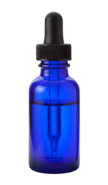 Blue Eye Dropper Bottle with a clipping path Blue Glass Eye Dropper Bottle With a black rubber  squeeze bulb. The dropper is used to distribute small quantities of medicine. The image is isolated on a white background, and includes a clipping path. glass medicine blue bottle stock pictures, royalty-free photos & images