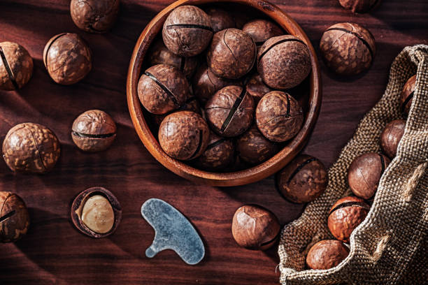 istock Macadamia Nuts On Vintage Wood Close up. 1591818331