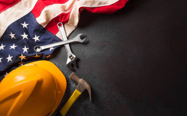 istock Happy Labor day concept. American flag with different construction tools on dark background. 1591818390