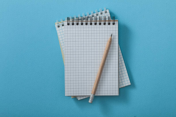 istock Opened Notepads With Pencil On Blue Background. 1591819496