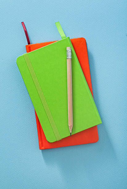 istock Wooden Pencil On Note Pads Close Up. 1591820679