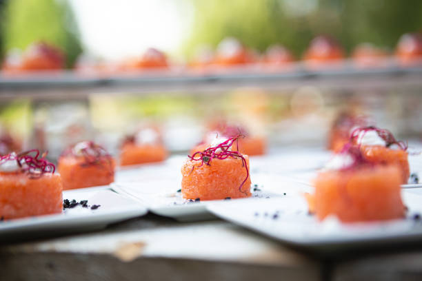 istock Salmon roll served at a wedding buffet. Finger food served on a white background 1591866185