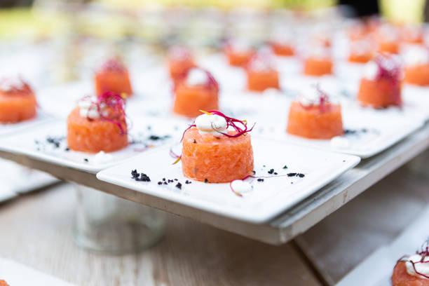 Salmon roll served at a wedding buffet. Finger food served on a white background.