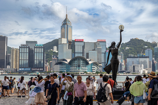 Hong Kong - August 4, 2023 : People at the Avenue of Stars along the Victoria Harbour waterfront in Tsim Sha Tsui, Kowloon, Hong Kong.