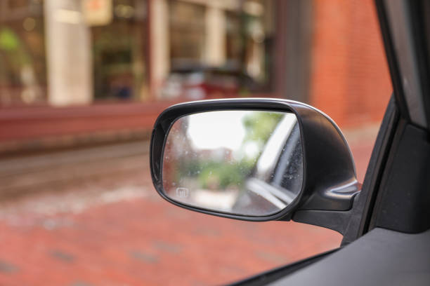 istock Car mirror reflects life's journeys, offering introspection and foresight. Symbolizes reflection, self-awareness and moving forward 1591887705