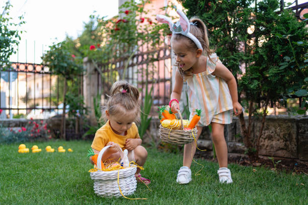 istock Caucasian toddler girls having fun during an Easer egg hunt 1591896983