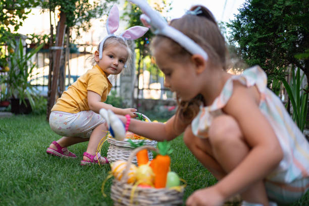 istock Caucasian toddler girls having fun during an Easer egg hunt 1591897511