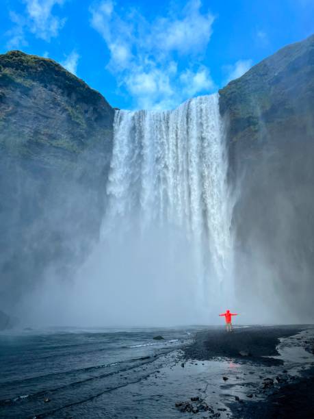 istock Person with Majestic Icelandic Waterfall 1591909843