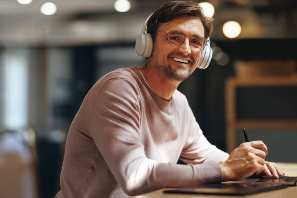 istock Happy graphic designer working on a project in a cafe 1591926831