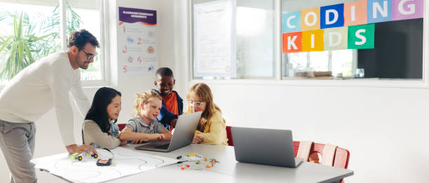 istock Primary school children learn robot programming with their teacher's guidance 1591933560