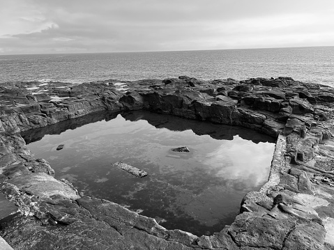 A rock pool against the North Sea at Whitley Bay