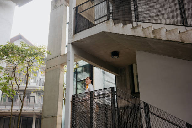 istock Asian woman in a modern office park 1591938489