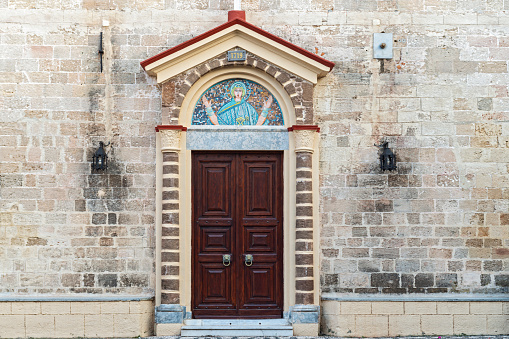 The historic church wall and the door above it.