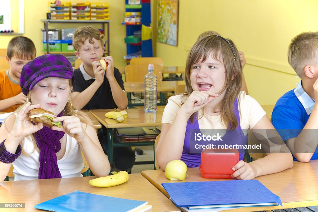 Lunch Time Lunch time in a school. Children are eating some bulb. Child Stock Photo