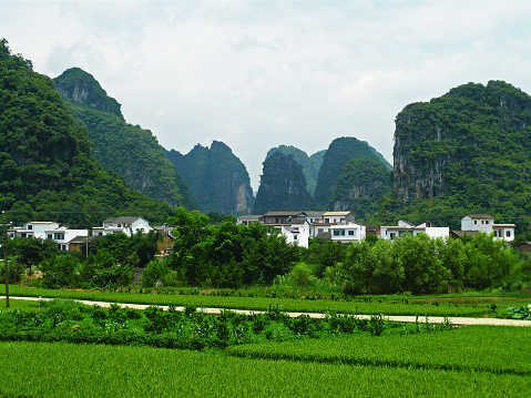 Civilian houses in Guilin, China, with mountains featuring the Karst formation.