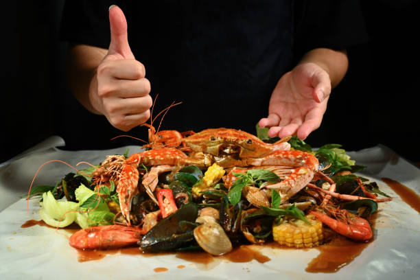 istock Chef cooking mixed seafood on paper plate 1592011729