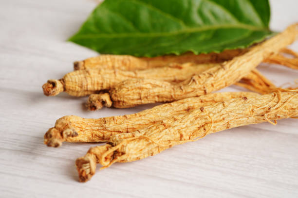 istock Ginseng roots and green leaf, healthy food. 1592046109
