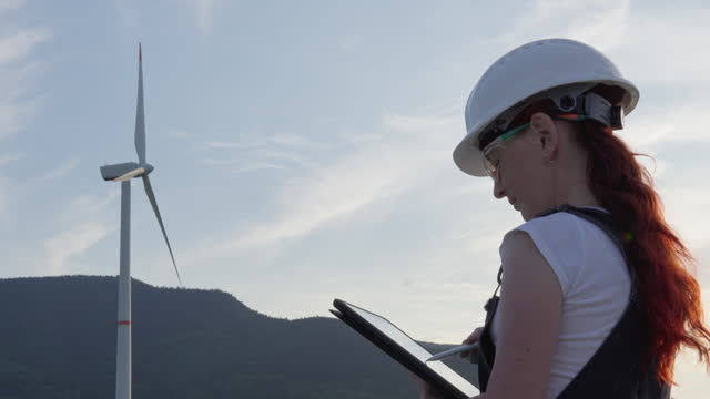 The video demonstrates the work of an engineer who analyzes and monitors the operation of a wind turbine, ensuring uninterrupted production of environmentally friendly electricity. Woman works at work