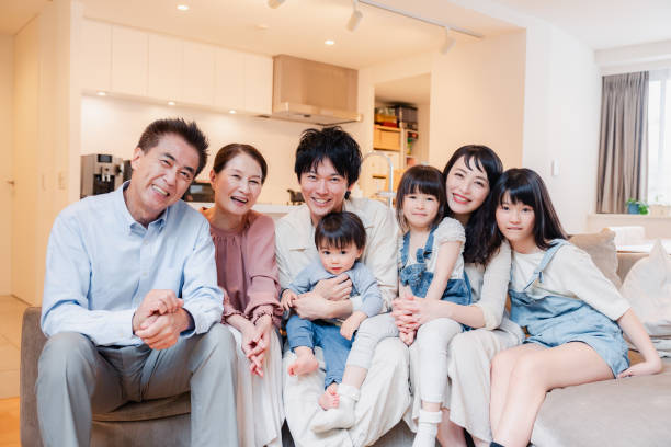 istock Smiling three-generation family group photo 1592087886