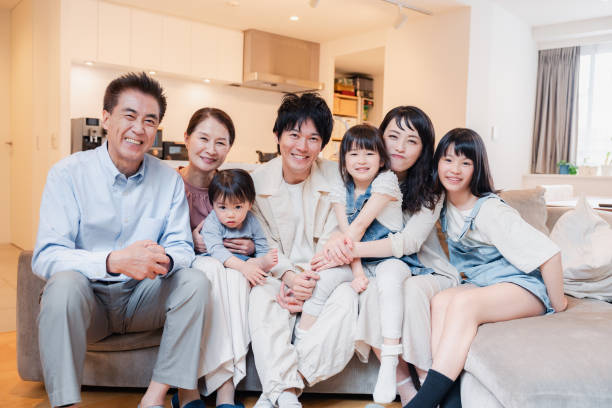 istock Smiling three-generation family group photo 1592087889