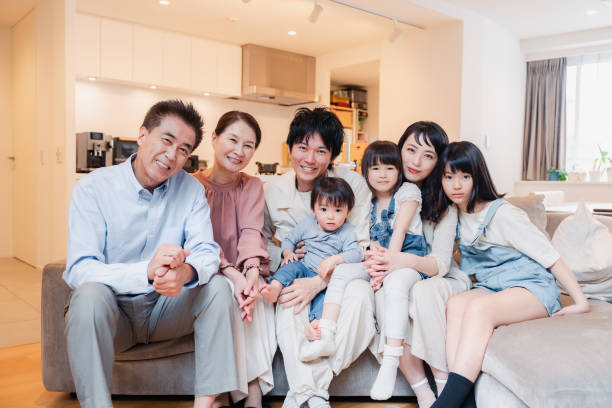 istock Smiling three-generation family group photo 1592087891
