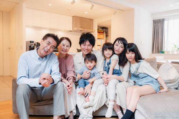istock Smiling three-generation family group photo 1592087894