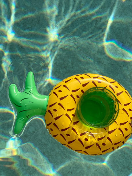 istock fresh  glass with water and mint floating  in a funny inflatable 1592090168