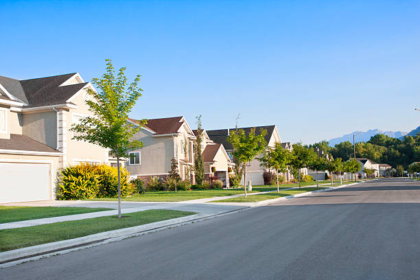 Peaceful Neighborhood A peaceful, quiet street in a middle-class North American neighborhood suburb house street residential district stock pictures, royalty-free photos & images